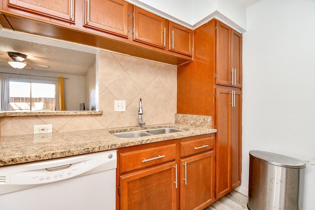 10555 Turtlewood Ct Unit 2606, Houston, TX 77072 - kitchen with a sink, decorative backsplash, dishwasher, and brown cabinets