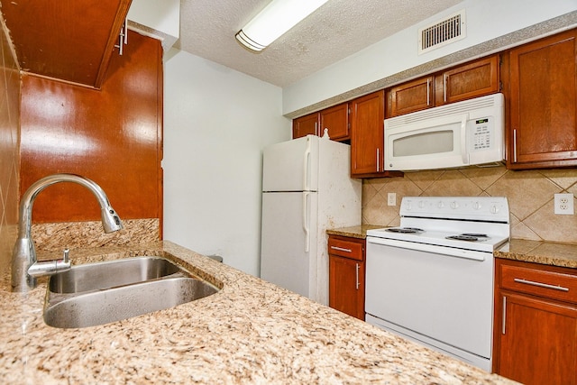 10555 Turtlewood Ct Unit 2606, Houston, TX 77072 - kitchen featuring tasteful backsplash, white appliances, light countertops, visible vents, and a sink
