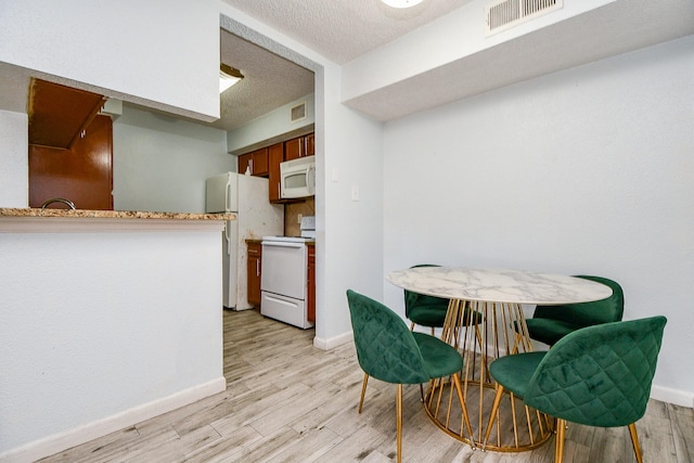 10555 Turtlewood Ct Unit 2606, Houston, TX 77072 - dining area with light wood-style flooring, baseboards, and visible vents