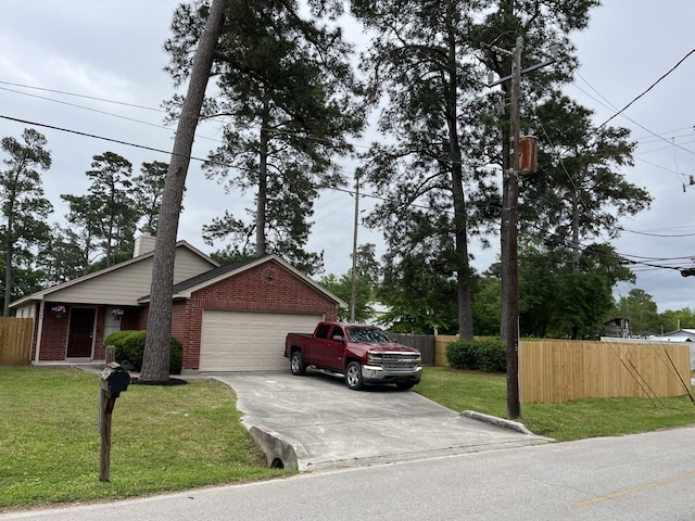 27806 Red Fox Rd, Tomball, TX 77377 - view of front of house with an attached garage, fence, driveway, and a front lawn