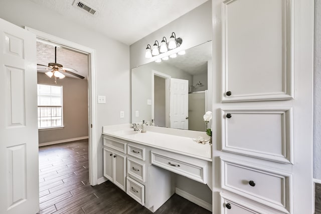 27806 Red Fox Rd, Tomball, TX 77377 - full bath featuring vanity, baseboards, a ceiling fan, visible vents, and wood finished floors