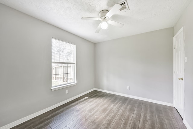 27806 Red Fox Rd, Tomball, TX 77377 - unfurnished room with visible vents, baseboards, a ceiling fan, a textured ceiling, and wood finished floors