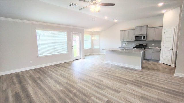 9 Gemstone Ct, Angleton, TX 77515 - kitchen featuring stainless steel appliances, gray cabinetry, vaulted ceiling, decorative backsplash, and ceiling fan