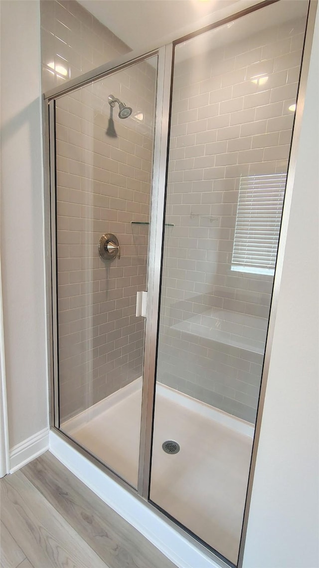9 Gemstone Ct, Angleton, TX 77515 - bathroom with a stall shower and wood finished floors