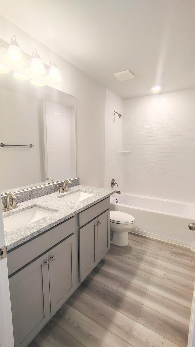 9 Gemstone Ct, Angleton, TX 77515 - bathroom with double vanity, toilet, wood finished floors, and shower / bathtub combination