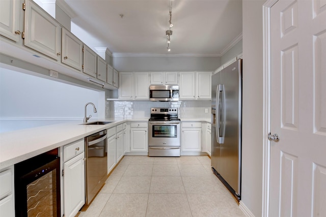 2111 Welch St Unit A107, Houston, TX 77019 - kitchen with appliances with stainless steel finishes, beverage cooler, a sink, track lighting, and decorative backsplash