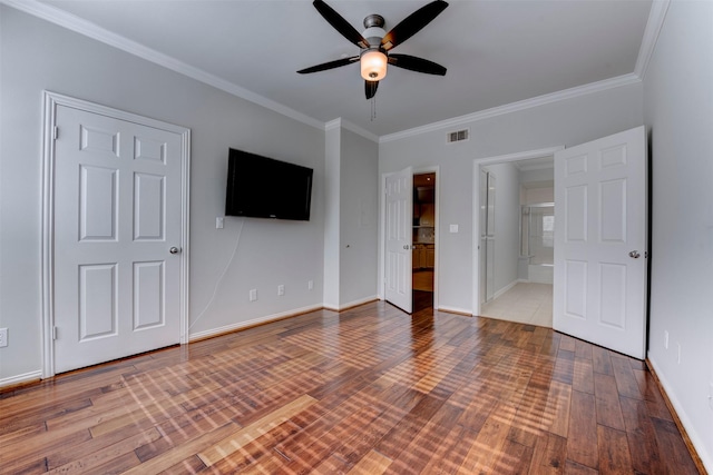 2111 Welch St Unit A107, Houston, TX 77019 - unfurnished bedroom featuring ornamental molding, wood finished floors, baseboards, ensuite bathroom, and ceiling fan