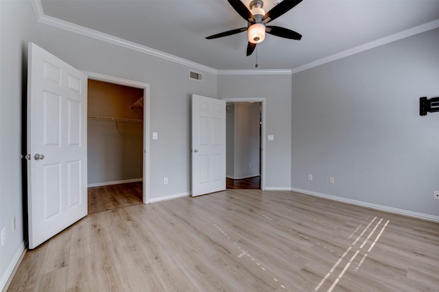 2111 Welch St Unit A107, Houston, TX 77019 - unfurnished bedroom featuring ornamental molding, light wood-style floors, baseboards, a spacious closet, and ceiling fan