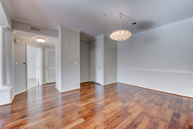 2111 Welch St Unit A107, Houston, TX 77019 - empty room with light wood finished floors, crown molding, baseboards, and ornate columns