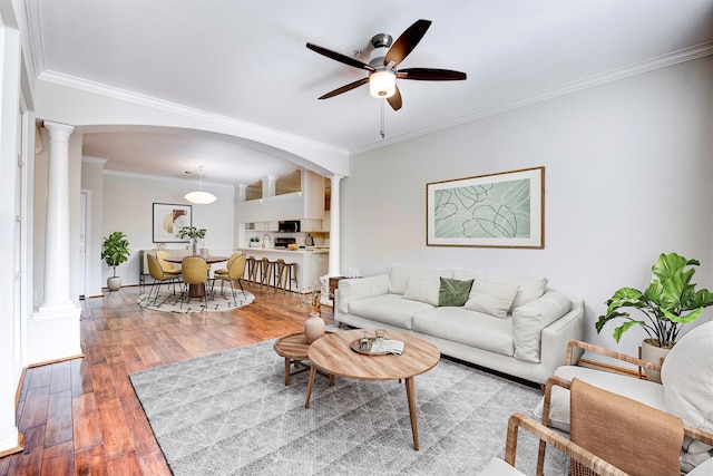 2111 Welch St Unit A107, Houston, TX 77019 - living area with ornate columns, arched walkways, ceiling fan, wood-type flooring, and crown molding