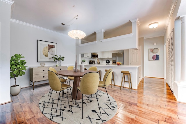 2111 Welch St Unit A107, Houston, TX 77019 - dining room with crown molding, light wood-style floors, and baseboards