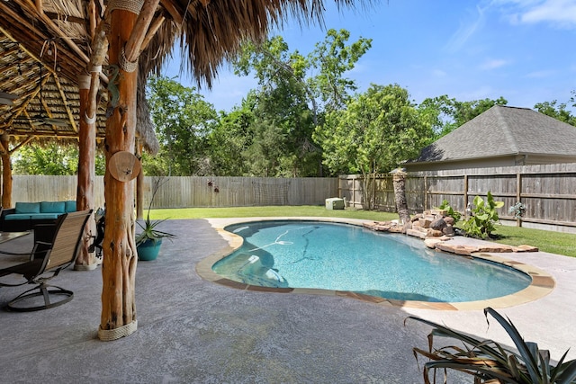 view of swimming pool with a fenced backyard, a fenced in pool, and a patio