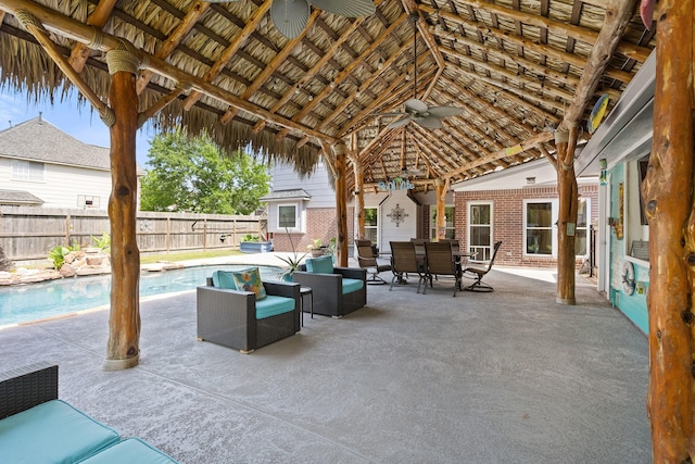 view of patio featuring a fenced backyard, a ceiling fan, a gazebo, outdoor dining space, and a fenced in pool
