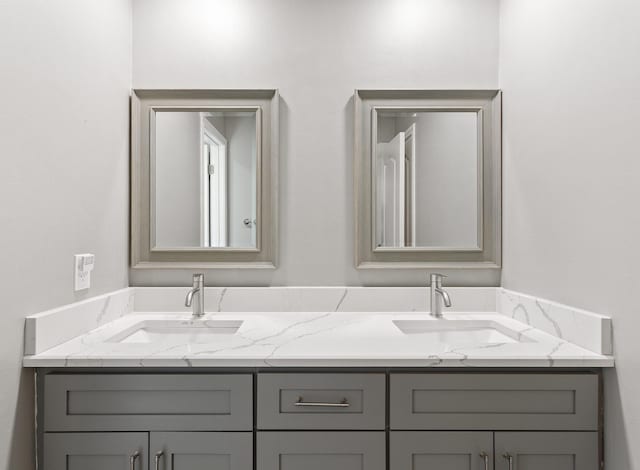full bath featuring a sink and double vanity