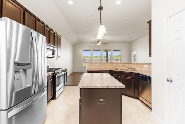 2451 Porto Way, League City, TX 77573 - kitchen with ceiling fan, tasteful backsplash, dark brown cabinets, appliances with stainless steel finishes, and a sink