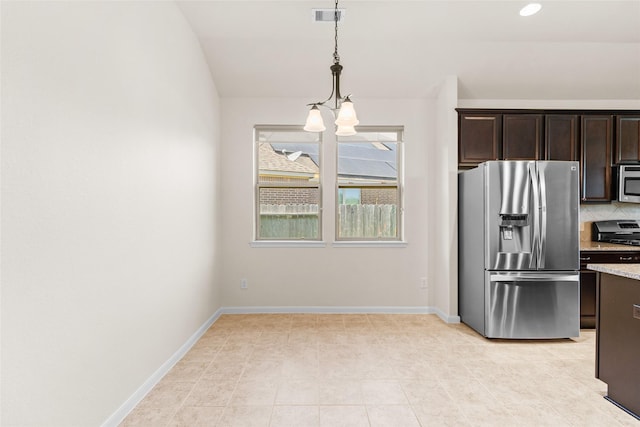 2451 Porto Way, League City, TX 77573 - kitchen with visible vents, appliances with stainless steel finishes, dark brown cabinets, pendant lighting, and decorative backsplash