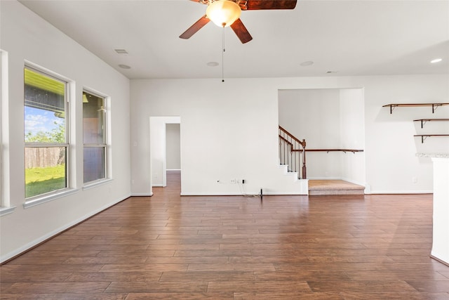 2451 Porto Way, League City, TX 77573 - unfurnished living room with ceiling fan, dark wood finished floors, visible vents, stairway, and baseboards