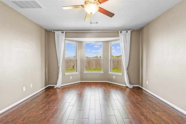 2451 Porto Way, League City, TX 77573 - unfurnished room with dark wood-type flooring, visible vents, baseboards, and a ceiling fan