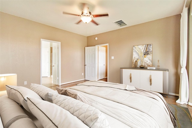 2451 Porto Way, League City, TX 77573 - bedroom with ceiling fan, visible vents, baseboards, and wood finished floors