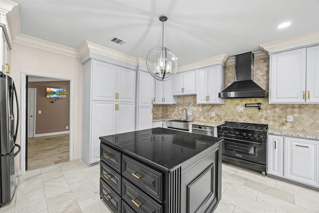 509 Joan Of Arc Dr, Hempstead, TX 77445 - kitchen featuring wall chimney exhaust hood, stainless steel appliances, a chandelier, a sink, and crown molding