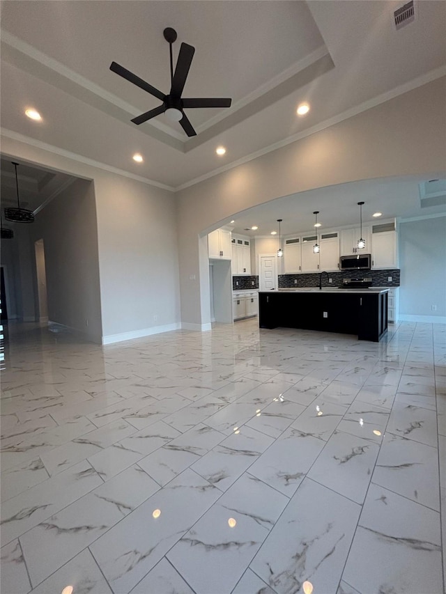 5398 Kyla Cir, Katy, TX 77493 - unfurnished living room featuring crown molding, a tray ceiling, and visible vents