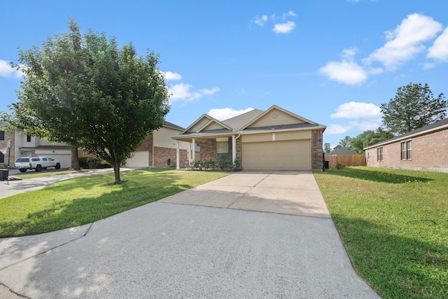 view of front of home with a front lawn, concrete driveway, fence, brick siding, and an attached garage
