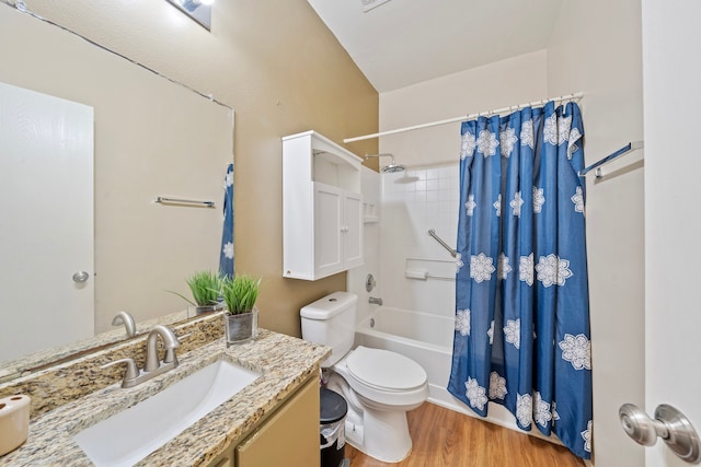 bathroom with wood finished floors, shower / bath combo with shower curtain, toilet, and vanity