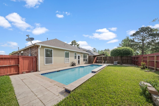 view of pool with a fenced backyard, a patio area, a fenced in pool, and a lawn