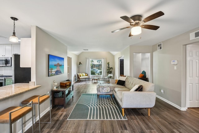 living area with dark wood finished floors, a ceiling fan, baseboards, vaulted ceiling, and visible vents