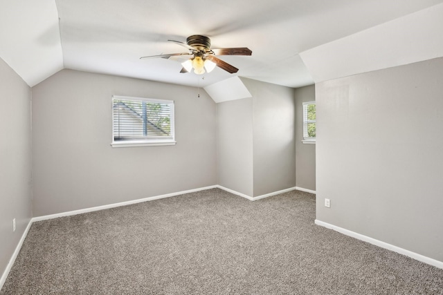 additional living space featuring carpet floors, baseboards, ceiling fan, and vaulted ceiling