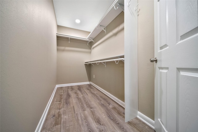 2201 Badger Ln, Huntsville, TX 77320 - walk in closet featuring wood finished floors and attic access