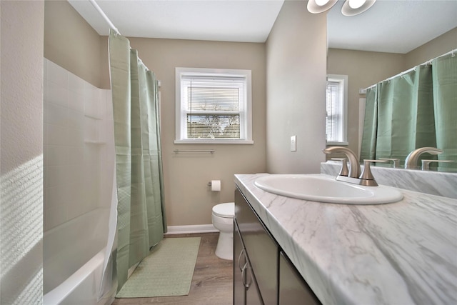 2201 Badger Ln, Huntsville, TX 77320 - full bath with vanity, baseboards, shower / bath combo, toilet, and wood finished floors