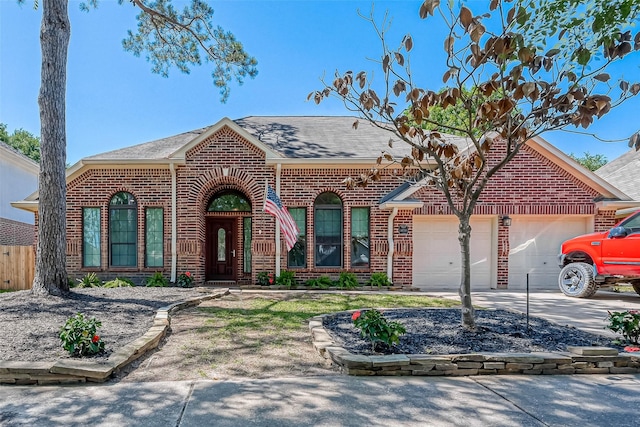 ranch-style home with brick siding, roof with shingles, concrete driveway, and an attached garage