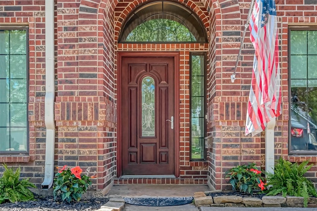 property entrance featuring brick siding