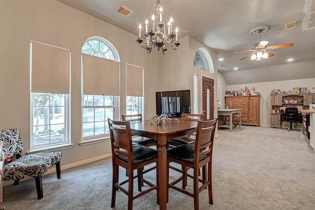 dining space featuring high vaulted ceiling, visible vents, light carpet, baseboards, and ceiling fan with notable chandelier
