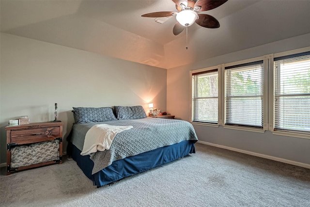 bedroom featuring baseboards, a ceiling fan, carpet floors, and multiple windows