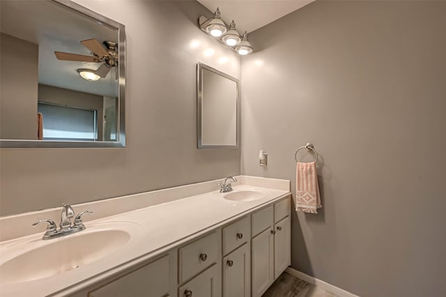 bathroom with ceiling fan, double vanity, and a sink
