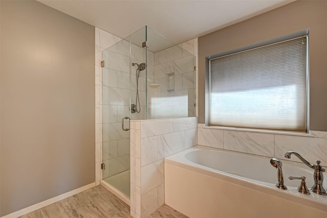 full bathroom featuring baseboards, a shower stall, a bath, and marble finish floor