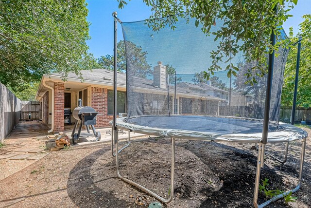 14718 Cypress Green Dr, Cypress, TX 77429 - view of swimming pool featuring area for grilling, a fenced backyard, and a trampoline