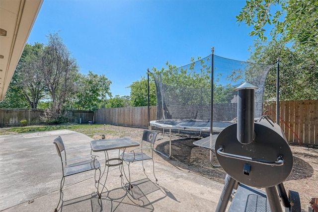 view of patio / terrace featuring a fenced backyard and a trampoline