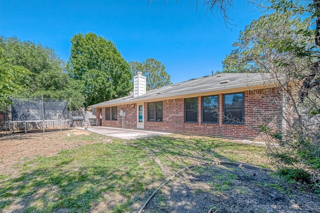 14718 Cypress Green Dr, Cypress, TX 77429 - back of house featuring fence, a patio, brick siding, and a trampoline