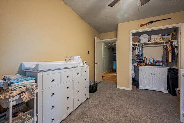 carpeted bedroom featuring a closet, ceiling fan, and a textured ceiling