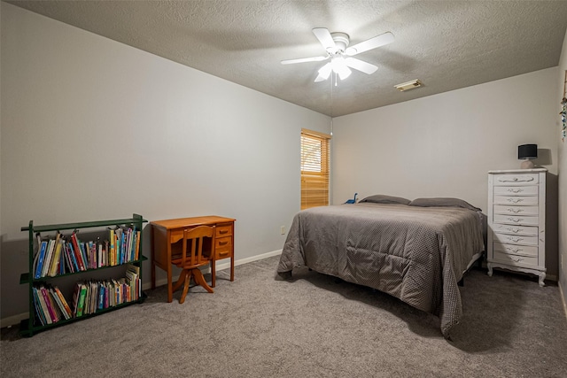 carpeted bedroom featuring baseboards, visible vents, ceiling fan, and a textured ceiling