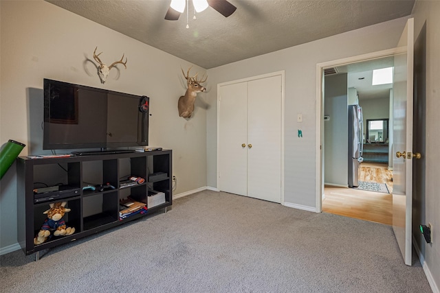 interior space featuring baseboards, freestanding refrigerator, and carpet floors