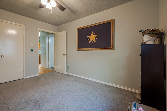 14718 Cypress Green Dr, Cypress, TX 77429 - unfurnished bedroom with a textured ceiling, a ceiling fan, carpet flooring, and baseboards