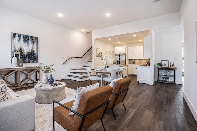 living area with stairs, dark wood-style floors, recessed lighting, and baseboards