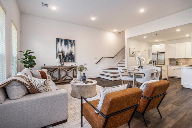living area with stairway, dark wood-style flooring, and recessed lighting