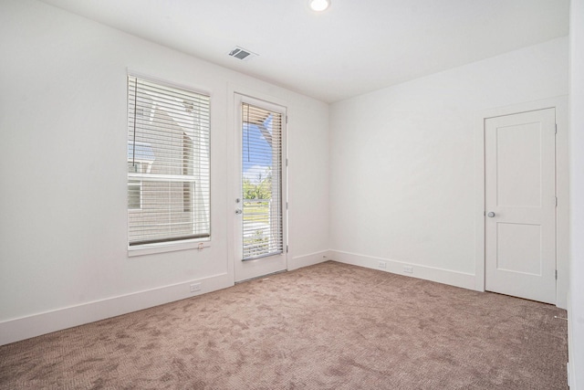 empty room featuring carpet flooring and baseboards