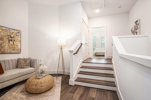 stairway featuring wood finished floors, baseboards, recessed lighting, and attic access