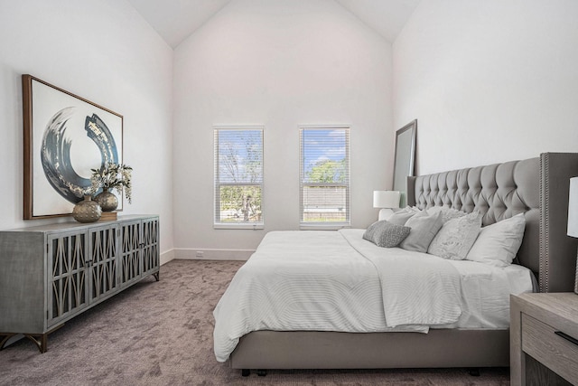 bedroom with carpet, baseboards, and high vaulted ceiling
